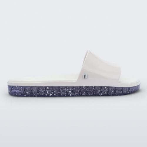 Side view of a white Melissa Beach slide with clear/glitter sole.