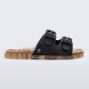 An outter side view of a Black/Beige Mini Melissa Wide Slide with a black top with two black buckles and a beige sole.