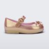 An outter side view of a pink Mini Melissa Sweet Love flat with a top strap and a bow detail on the toe.