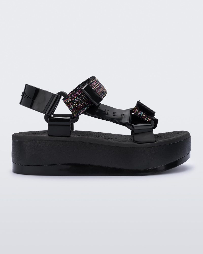 An outter side view of a black Melissa Papete Platform sandal with a black multicolor straps.