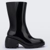 Side view of a Melissa Nancy heeled boot in black, with calf height shaft.