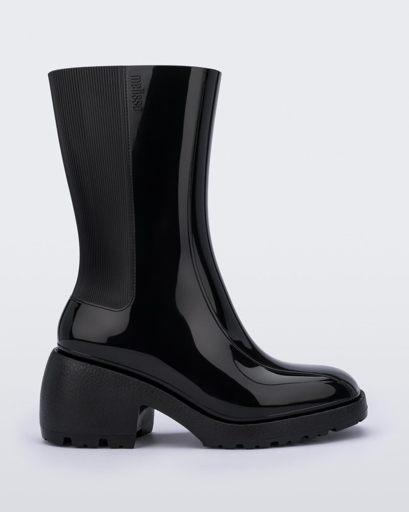 Side view of a Melissa Nancy heeled boot in black, with calf height shaft.