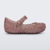 Side view of Mini Melissa Campana rose glitter flats with a snap strap for baby with an open woven texture