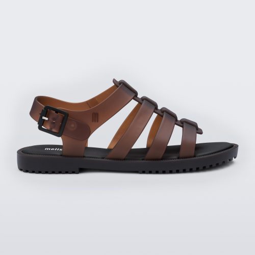 Side view of a clear brown Melissa Flox sandal with a black sole and straps.