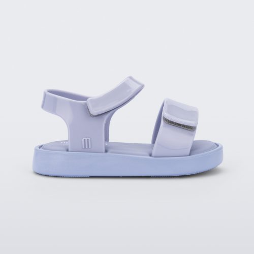 Side view of a purple Mini Melissa Jump sandal with velcro straps.