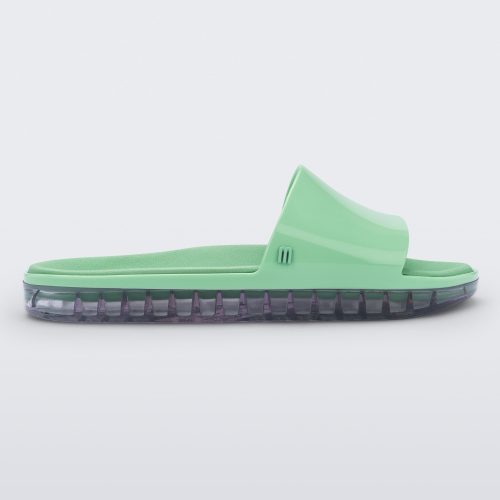 Side view of a green Melissa Beach slide with clear sole.