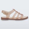 Side view of a beige Melissa Flox sandal with straps.