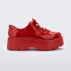 Side view of a Melissa Kick Off sneaker in red with platform sole and red shoe laces