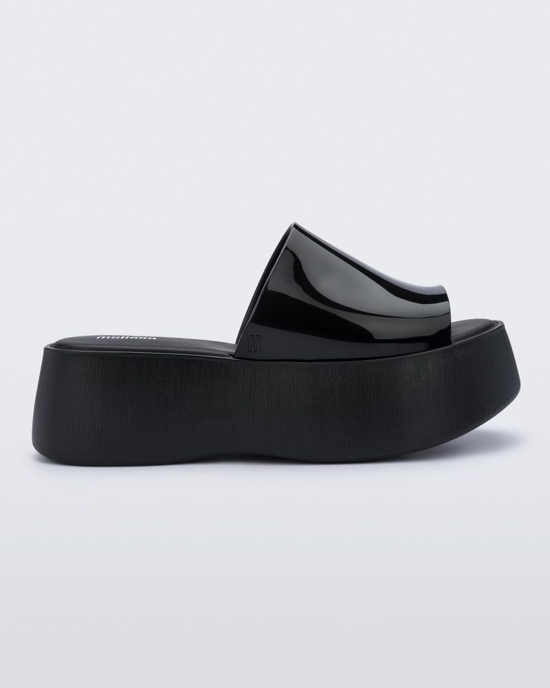 Side view of a black Melissa Becky platform slide.