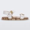 Side view of a Melissa Wide Papete sandal with gold glitter sole and white velcro straps